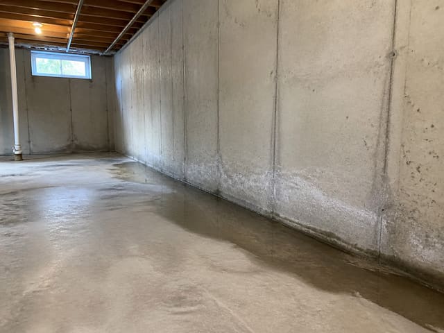 Interior French drain along basement perimeter capturing groundwater